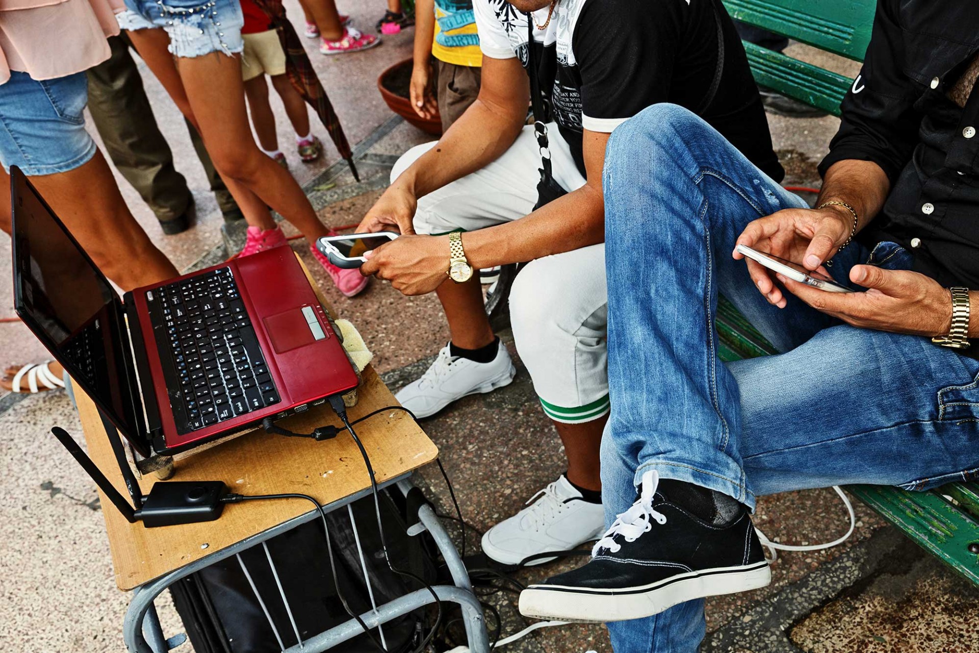 People around a laptop using the Internet