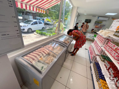 mujer vestida de rojo examinando un mostrador de comida