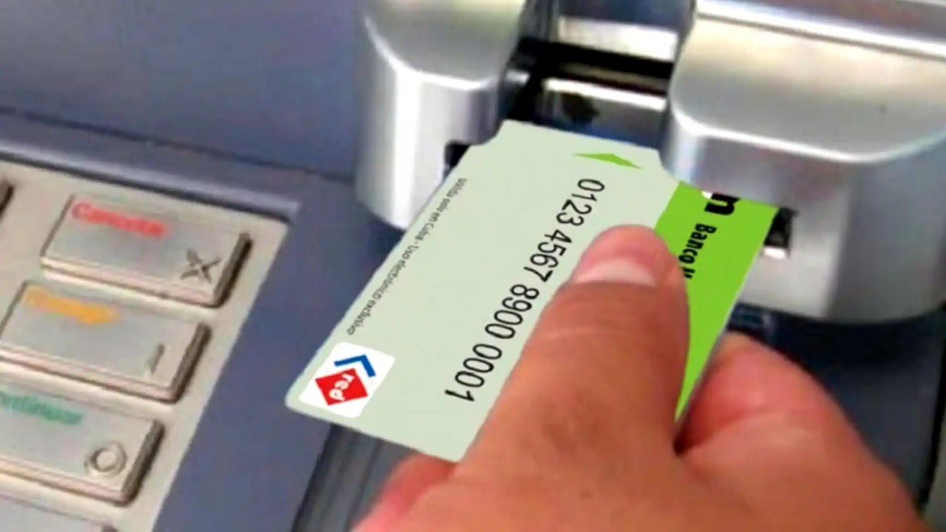 hand putting a card into an electronic ATM