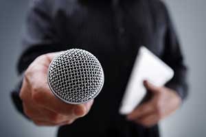 Brian Jackson/stockadobe.com Man holding a microphone