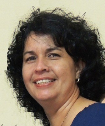 smiling woman with dark hair and dark blue top