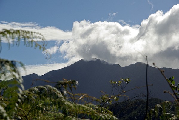 Image of top of mountain surrounded by clouds