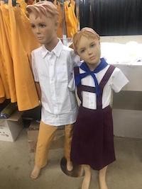 two child mannequins wearing Cuban school uniforms