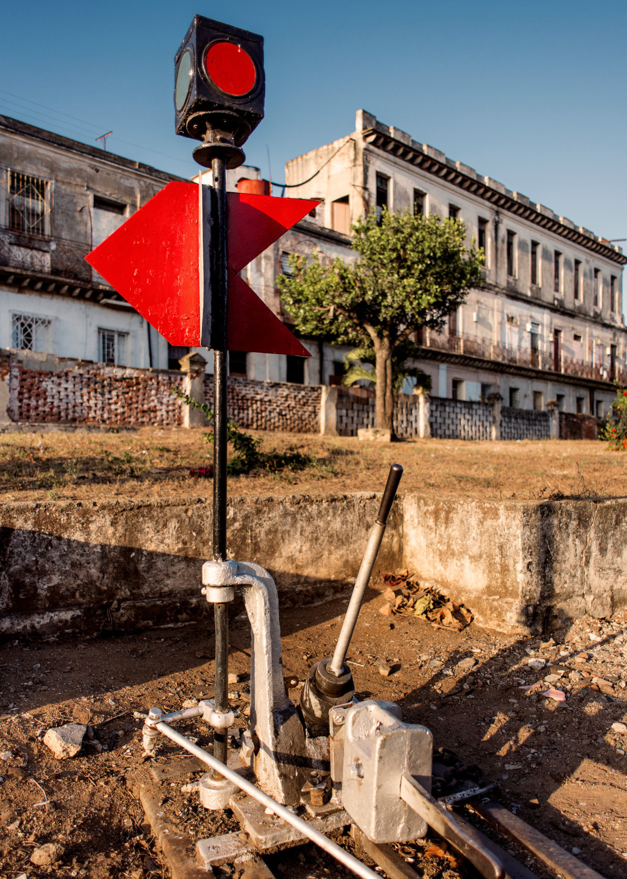 By Rolf G. Wackenberg/stockadobe.com Industrial property in Camagüey, Cuba, crumbling, with a red light in the center