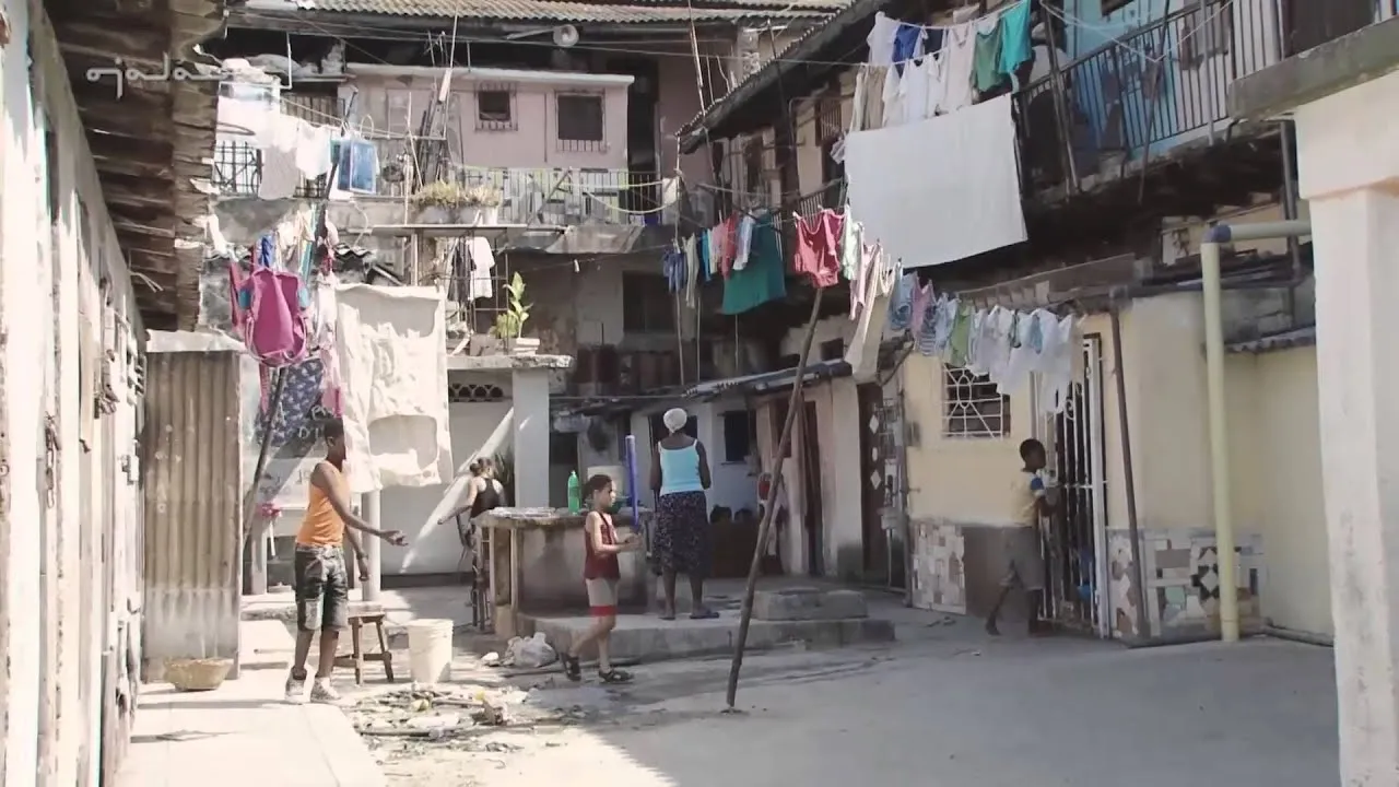 the patio of a housing complex with hanging clothes lines