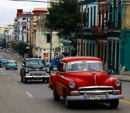 línea de autos antiguos americanos pasando por La Habana