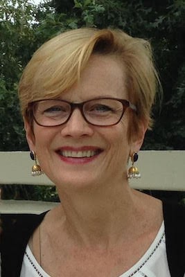 smiling blonde woman with glasses black and white clothing